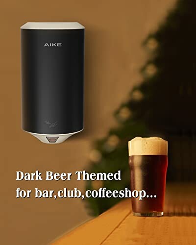 Wall-mounted dispenser and dark beer glass on table.