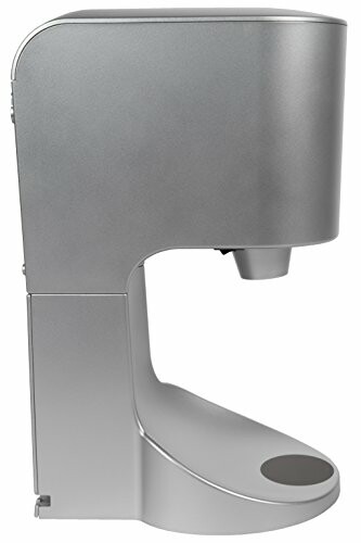 Side view of a modern silver hand dryer in use